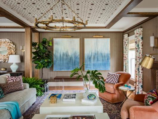 Redesigned Family room with custom ceiling blue abstract paintings on the wall and coral chairs